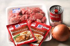 some food is laying out on a table next to a can of brown gravy