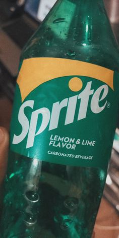 a bottle of sprite lemon and lime flavored beverage sitting on a counter top