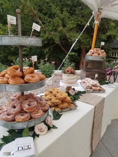 a table topped with lots of donuts and other pastries on top of it