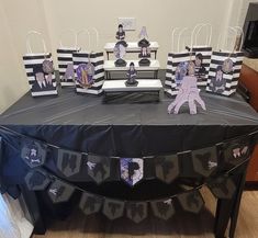 a table with black and white paper decorations on it, along with other party items