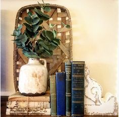 some books and a vase on a table