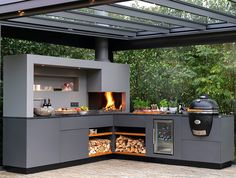 an outdoor kitchen with wood burning in the oven