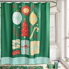 a green shower curtain with christmas decorations and gifts on it in front of a window