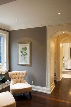 a living room filled with furniture next to a large open window on top of a hard wood floor