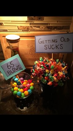 two buckets filled with candy sitting next to each other on top of a table