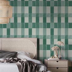 a bedroom with green and white checkered wallpaper, a wicker basket hanging over the bed