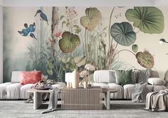 a living room filled with lots of furniture next to a wall mural on the wall