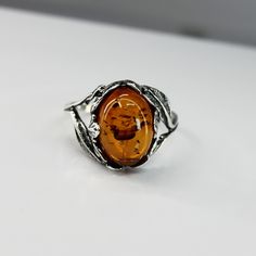 Elegant 925 silver ring with high-quality amber (nickel-free). size 20; circumference 60 mm; Inner diameter 19.1mm Stone length: 15 mm, stone width: 10 mm Discover the perfect blend of classic elegance and modern style with our high quality 925 silver ring, adorned with a stunning amber. Each ring is crafted with meticulous attention to detail, ensuring a luxurious and long-lasting finish. The warm glow of the amber complements the shine of the silver, creating a piece that is not only beautiful Silver Baltic Amber Rings As Gift, Oval Baltic Amber Rings In Amber Color, Oval Baltic Amber Ring In Amber, Oval Baltic Amber Ring, Amber Sterling Silver Oval Cabochon Ring, Amber Oval Cabochon Sterling Silver Ring, Amber Sterling Silver Ring With Oval Cabochon, Amber Bracelet, Amber Ring