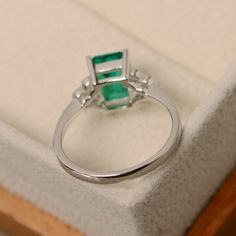 This ring features a 6*8mm emerald cut lab emerald and sterling silver finished with rhodium. Customization is available. It is made by hand, and it will take about 7 days to finish the ring after your payment is completed. Main stone: Lab emerald Main stone weight: Approx 1.40 ct Metal type: sterling silver finished with rhodium Accent stone: cz Customization is available, I also can make it with 14k solid gold (white or yellow or rose) and diamond accent stone, just feel free to contact me. An Promise Ring Emerald, Rectangle Ring, May Birthstone Rings, Ring Emerald, May Birthstone, Peridot Ring, Diamond Settings, Ring Promise, Ring Photos