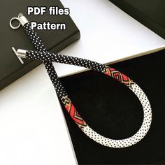 a black and white polka dot tie with a red, yellow and blue pattern on it