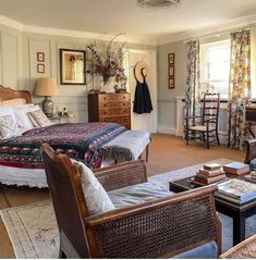 a bedroom with wicker furniture and floral curtains on the windowsills is pictured in this image