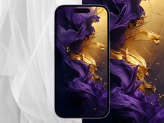 an image of two cell phones with purple and gold designs on them, next to each other