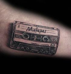 a black and white photo of a tattoo with a tape recorder on it's arm