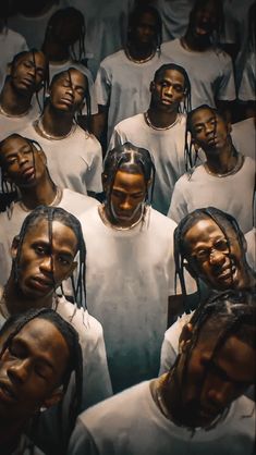 a group of young men standing next to each other in white shirts with dreadlocks on their heads