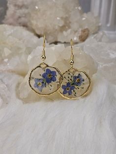 Beautiful forget me not flower earrings. Made with real dried, pressed flowers. Small and lightweight. Gold Plated earring wires.  Hypoallergenic.  Each pair will not look exactly like the picture. The pressed flowers are unique and different. Dainty Flower Earrings With Pressed Flowers, Dainty Pressed Flower Earrings, Gold Floral Print Earrings As Gift, Gold Floral Print Earrings For Gift, Gold Earrings With Floral Print For Gift, Dainty Round Pressed Flower Earrings, Pressed Flower Earrings, Pressed Flower Jewelry, Dried Pressed Flowers