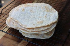 three tortillas sitting on top of a cooling rack