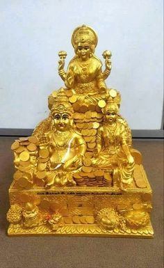 a golden buddha statue sitting on top of a pile of gold coins