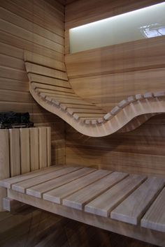 the inside of a sauna with wooden slats and shelves on each side for storage