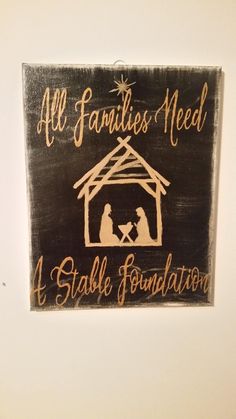 a wooden sign that says all families need a stable foundation with a nativity scene