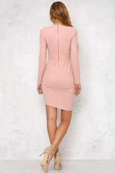 Turn heads with the Dangerous Woman Dress! This gorgeous blush dress has long sleeves, a visible back zip, a tulip skirt and a sultry peek-a-boo cutout in the front. We love the padded shoulders and bodycon fit for this dress - throw on a blazer for day and work the look with stiletto heels for night! Dress. Padded shoulders. Not lined. Cold hand wash only. Model is standard XS and is wearing XS. True to size. Non-stretchy fabric. Polyester. Vestidos Color Rosa, Blush Dress, Tulip Skirt, Woman Dress, Blush Dresses, Dangerous Woman, Peek A Boo, Stretchy Fabric, Night Dress