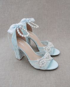 "Fun and flirty lace block heel sandals with pearl appliques. Perfect for weddings, parties, or any special occasion. DETAILS: HEEL HEIGHT: 3.6 inches COLORS AVAILABLE: Ivory, White and Light Blue UPPER: Synthetic upper and lining MATERIALS: Manmade outsole STYLE NAME: FAITH SIZE FIT: RUNS LARGE Not sure of which size to purchase? Shoes measurements are as follow: (Please note measurements taken the length of inside of shoe from toe to heel) SIZE 5 - 9.25\" SIZE 6 - 9.50\" SIZE 7 - 9.75\" SIZE 8 Spring Party Sandals With Lace, Spring Party Lace Sandals, Summer Lace Heels With Block Heel, Summer Lace Block Heel Heels, Lace Block Heel Party Shoes, Lace Block Heel Party Heels, Lace Block Heels For Party, Formal Open Toe Lace Sandals, Party Lace Block Heels