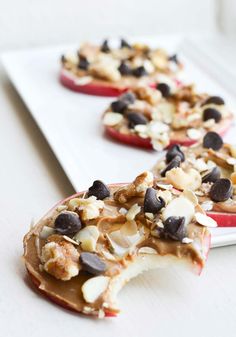 apple slices with chocolate chips and nuts on them