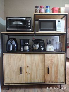 there is a microwave, toaster and coffee maker on the shelf