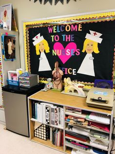 a bulletin board with nurses on it in front of a desk and bookshelf