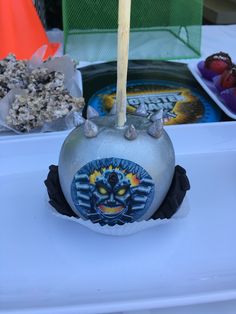 an odd looking object sitting on top of a white table next to other food items