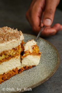 a person cutting into a piece of cake on a plate