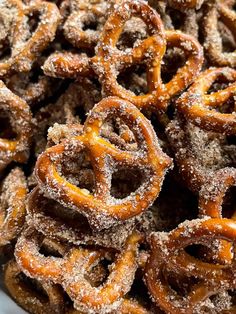 a bowl filled with sugar covered pretzels sitting on top of a table