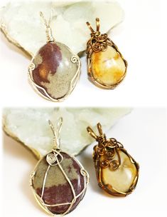 three pendants with different designs on them sitting on top of a rock next to each other