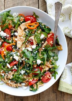 a white bowl filled with salad on top of a wooden table