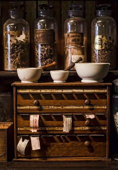 an old wooden dresser with jars and spices on it