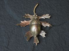 an acorn ornament on a black background