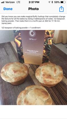 three pies sitting on top of a wooden table next to a box of food