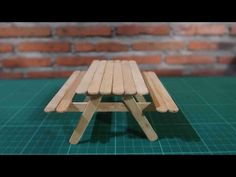 a small wooden stool sitting on top of a green table