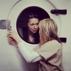 two women are looking into a washing machine