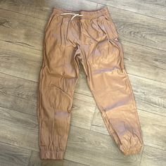 Brown Pleather Joggers With Draw String And Elastic Ankle. New Without Tags Size Large Casual Leather Bottoms With Pockets, Casual Brown Faux Leather Pants, Casual Leather Cargo Pants For Fall, Casual Faux Leather Bottoms For Spring, Casual Leather Pants For Fall, Casual Faux Leather Bottoms, Casual Leather Bottoms For Fall, Casual Faux Leather Pants For Spring, Spring Casual Faux Leather Pants