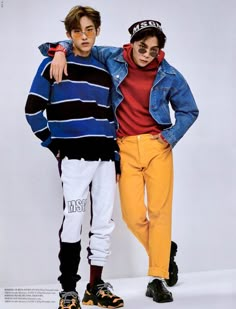 two young men standing next to each other in front of a white background wearing colorful clothing