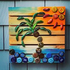 a palm tree made out of bottle caps on a wooden pallet