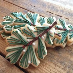 decorated cookies are sitting on a wooden table