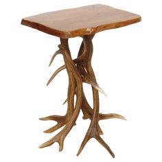 a small wooden table with antlers on it