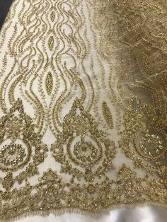 an embroidered fabric with gold thread and sequins