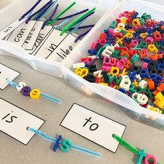 two bins filled with letters and numbers on top of a table next to each other