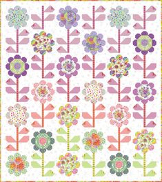 a colorful quilt with flowers on the front and back, all in different shades of pink