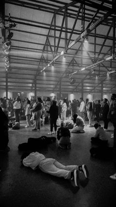 a group of people sitting and standing around in a building