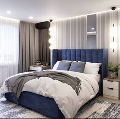 a bedroom with a blue headboard and white bedding