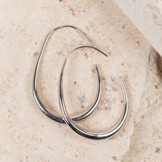 A modern take on the classic hoop, the Medium Graduated Oval Hoop Earrings feature a modern elongated oval hoop design. Chic and cute, these earrings are perfect for any occasion. These beautiful hoop earrings feature a long hoop back, keeping your earrings securely in place. Our Earrings are perfect for any age range and would make beautiful gift for any occasion and easily accentuates any style. Looking for the perfect gift? Our unique earring jewelry designs make this piece a wonderful presen Unique Earring, Presents For Wife, Elongated Oval, Oval Hoop Earrings, Hoop Design, Earring Jewelry, Silver Hoop Earrings, Unique Earrings, Jewelry Designs