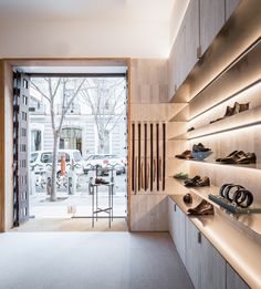 the inside of a shoe store with shoes on display